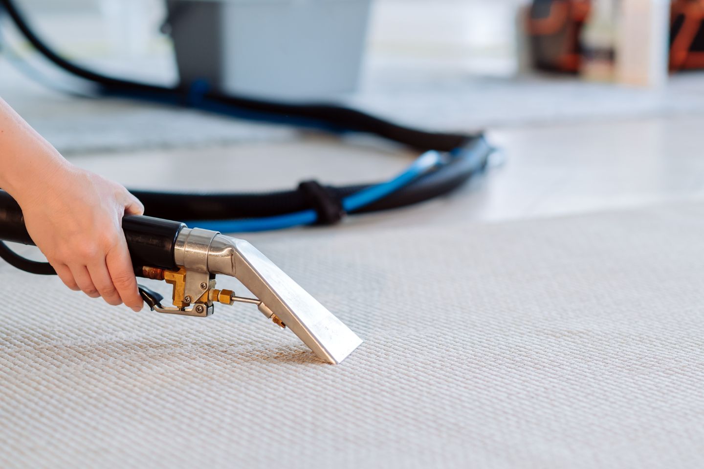 A person operates a vacuum cleaner on a carpet, illustrating a carpet mold removal service in Irvine, CA.